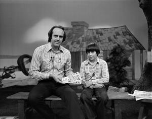 [Photograph of Bill Kelly and a boy at a Children's Hour product giveaway]