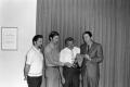 Photograph: [Don Day and men with an award]