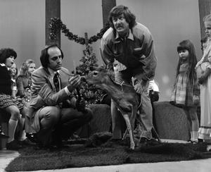 [Photograph of Bill Kelley with a deer at a KXAS Christmas Children's Hour party]