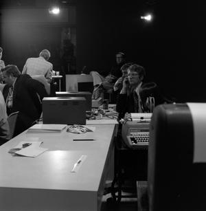 [Photograph of workers sitting at desks at the KXAS-TV station]