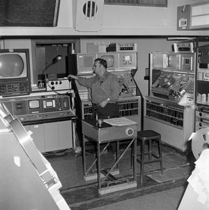 Primary view of object titled '[Unknown man in a control room]'.