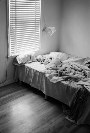 [Photograph of a little boy sleeping in bed]