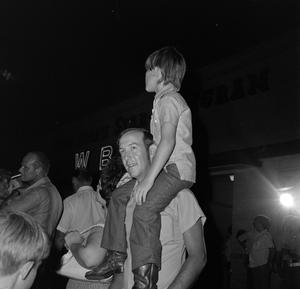 [Child on an adult's shoulders]