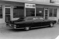 Photograph: [Car in front of a car rental building]