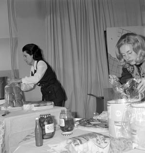 [Two women preparing food]