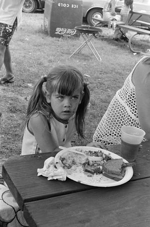 [A young girl with food]