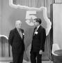 Photograph: [Two men in front of a Texas cutout]