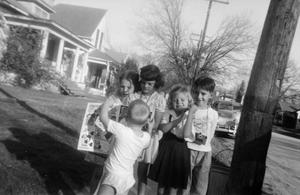 [Photograph of five children in a front yard]