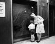 Primary view of [Woman and child near drinking fountains, 2]