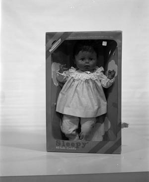 [African American toy in box]