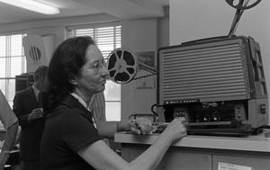 [Woman using a film projector, 2]