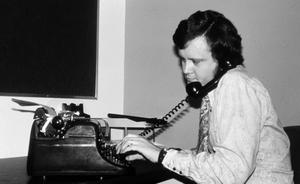 [A man using a typewriter]