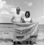 Photograph: [A couple with the Country Gold flag]