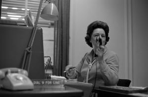 [Photo of an employee at a telephone switchboard]