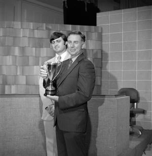 [Bob Walsh and unknown man with a trophy]