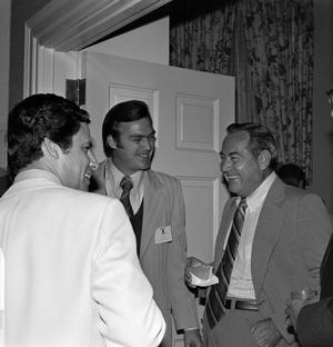 [Photograph of Russ Bloxom, Chip Moody and another man talking at an event]