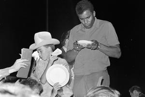 [Charley Pride signing autographs]