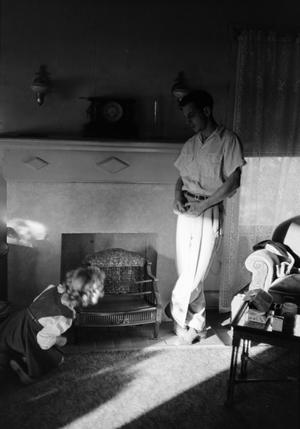[Photograph of Carol and Charles Williams in front of a fireplace]