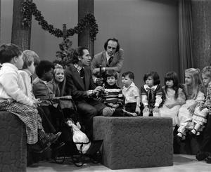 [Photograph of Bill Kelley interviewing a man at a KXAS Christmas Children's Hour party]