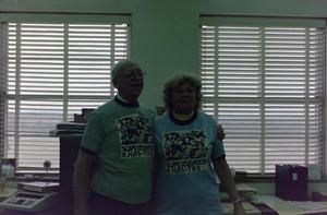 Primary view of object titled '[Two staff wearing KXAS Super Season T-shirts]'.