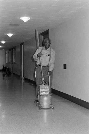 [Photograph of man cleaning]