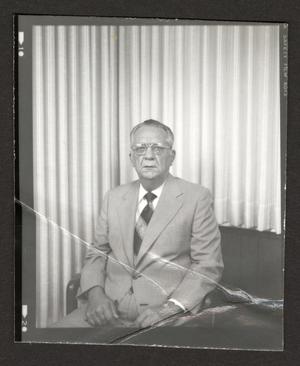[Photograph of a man in a suit and a red tie, 7]