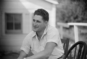 [Photograph of George Stiles sitting outdoors]
