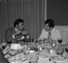 Primary view of [Photograph of two men at a table at an event]