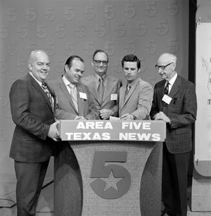 [Five men behind a WBAP podium]