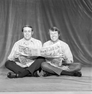 [Kneisel and Kelley holding a newspaper]