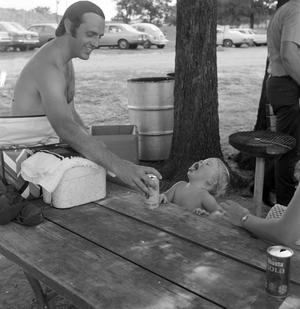 [Bill Kelley playing with a child]