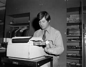 [Henry de La Garza using a typewriter]
