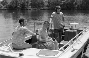 [Three young men on a boat]