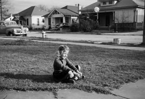 [Photograph of Carol Williams sitting in a front lawn]