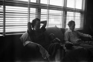 [Photograph of a man and a woman on a couch]