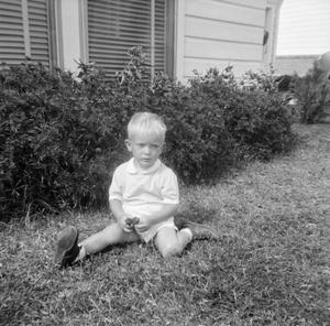 [Photograph of Curt Stiles Jr sitting in the grass]