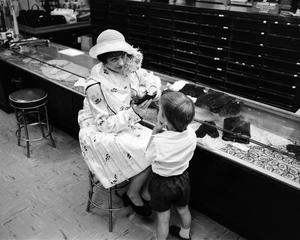 [A women and a child at a store, 8]