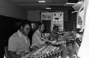 [Photograph of three employees at work in the studio]