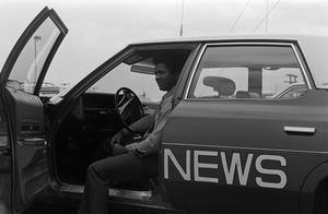 [KXAS employee sitting in a news automobile, 2]
