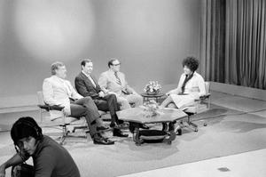 [Photograph of Sharon West with men on set at KXAS]