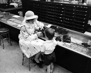 [A women and a child at a store, 6]