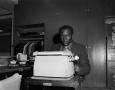Photograph: [Bill Willis using a typewriter]