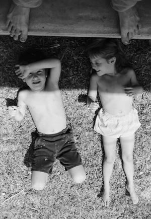 [Photograph of young Byrd IV and Pam Williams lying in the grass]