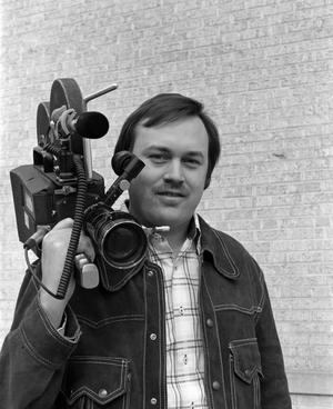 [Photograph of David Young posing with a camera]