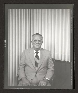 [Photograph of a man in a suit and a red tie, 8]