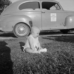 [Photograph of baby Paul sitting in the grass, 2]