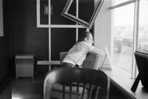 [Photograph of Charles Williams looking out a window]