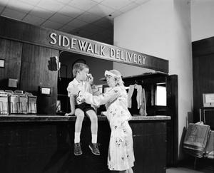 [Woman and a child at an establishment, 4]
