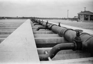[Photograph of pipes at a water or gas plant]