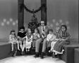 Photograph: [Photograph of Bill Kelley posing with children at a KXAS Christmas C…